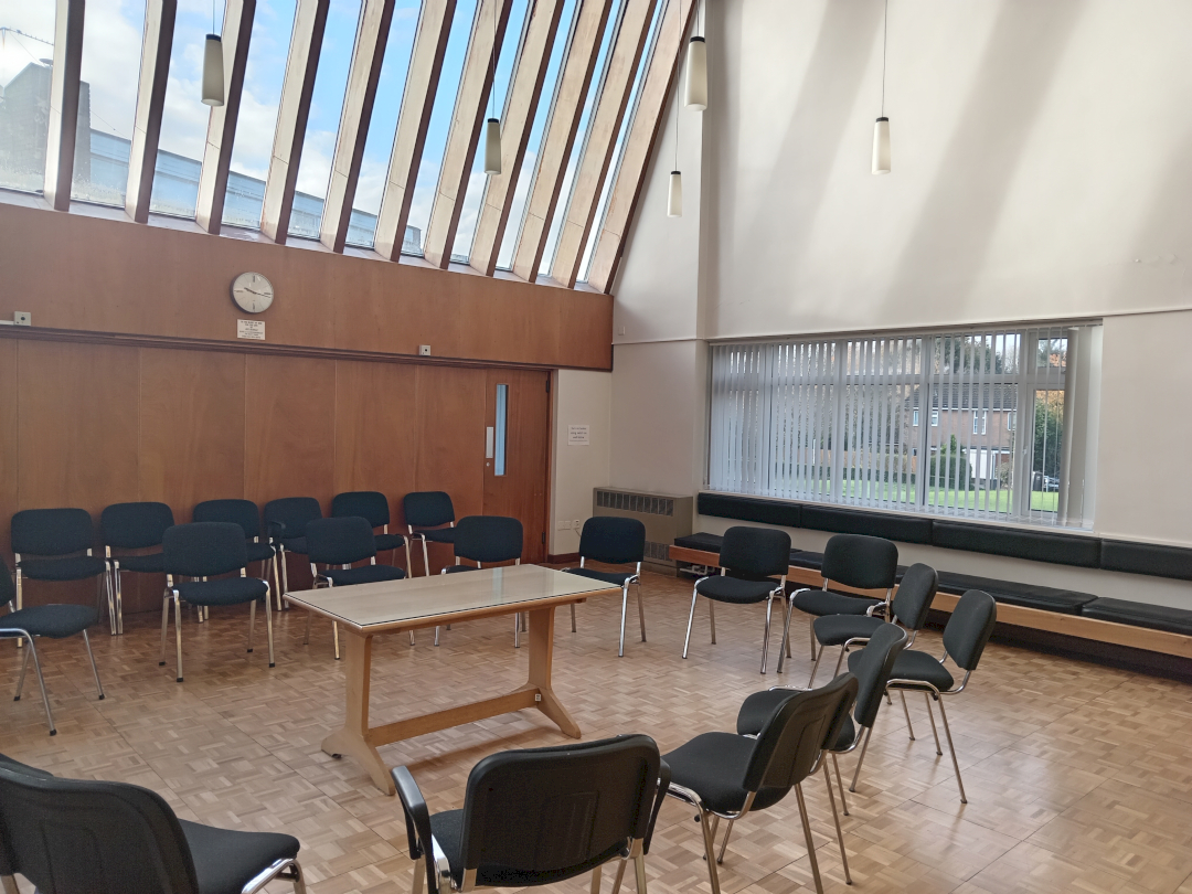 An image of the main meeting room in Hartshill Quaker meeting house with chairs in a circle